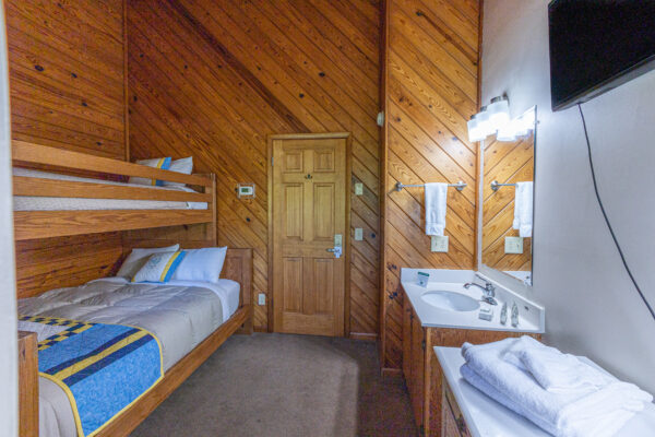 dogwood motel bunk room with private sink and tv