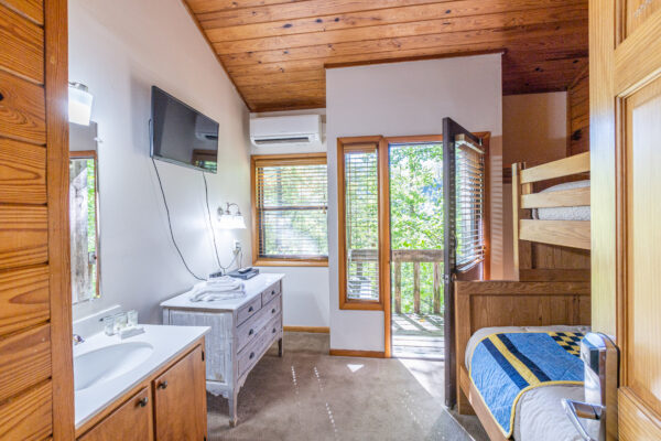 dogwood motel private bunk room with queen and twin bed and private patio facing forest