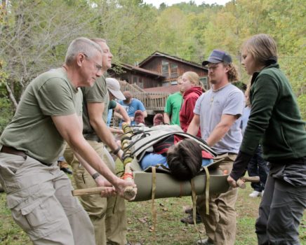 Carrying a person on a stretcher during the Advanced Wilderness First Aid (AWFA) Certification Course