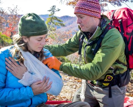 Wrapping a girls arm during the Advanced Wilderness First Aid (AWFA) Certification Course
