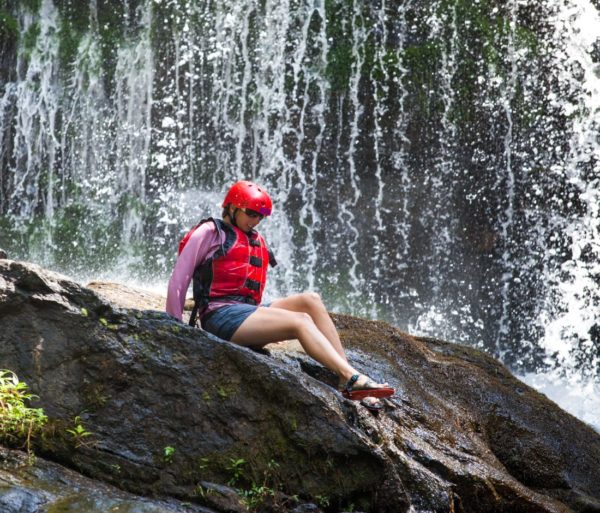 Guest sliding down a rock on the Chattooga River Rafting: Section IV (with Lunch) trip