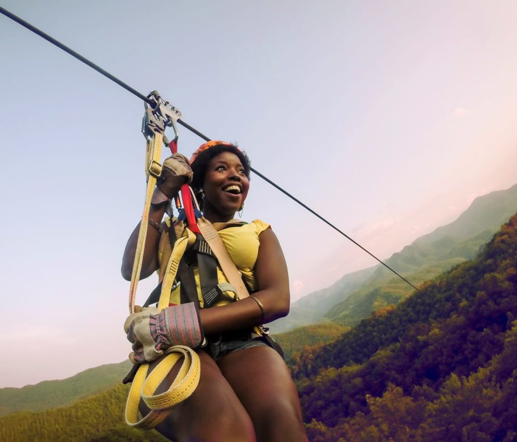 Guest on zip line on the Mountaintop Zip Line Tour