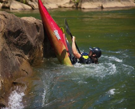 Kayaker doing a trick while on the Slicey Boat Clinic: Ocoee River