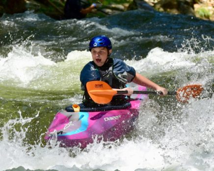 Kayaker on a river during Advanced Teen Kayak Camp