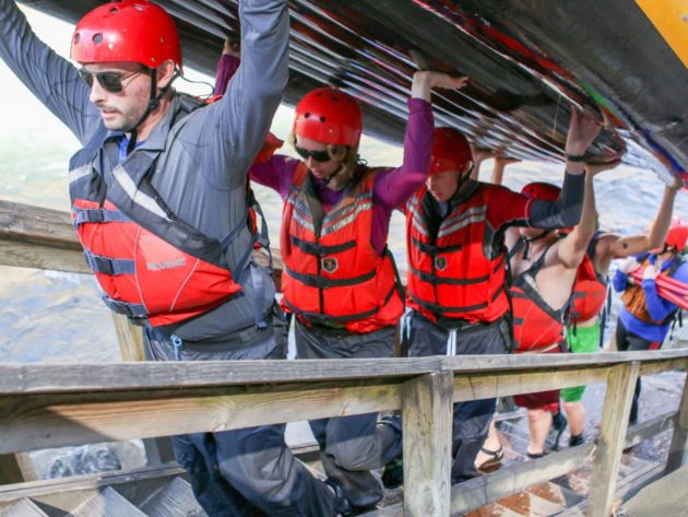 Carrying a raft up a staircase during Raft Guide School