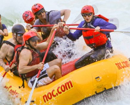 guides rafting in white water during raft guide school