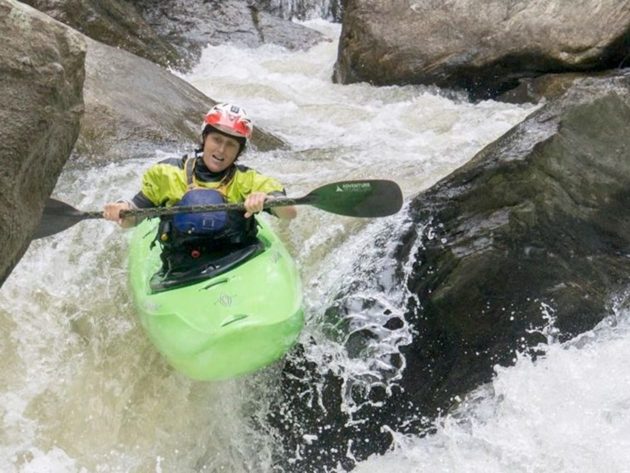 Anne kayaking through rapids on the NOC Women's Kayak Retreat